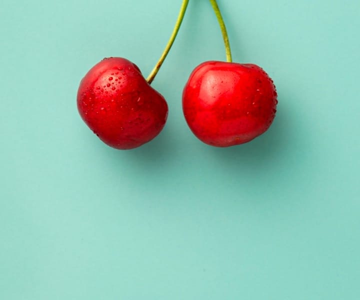 red cherries with green background 